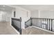 Upstairs hallway featuring neutral carpet and black railing at 7129 S Stadium Way, Gilbert, AZ 85298