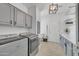 Well-equipped laundry room with gray cabinets, modern appliances, and a convenient folding area at 7129 S Stadium Way, Gilbert, AZ 85298