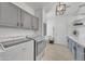 Laundry room with grey cabinets, modern light fixture, and new appliances at 7129 S Stadium Way, Gilbert, AZ 85298