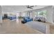 Spacious living room with large windows, tiled floors, blue couch and modern decor at 7129 S Stadium Way, Gilbert, AZ 85298
