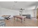 Spacious living area with hardwood floors, neutral walls, a pool table, and a foosball table at 7129 S Stadium Way, Gilbert, AZ 85298