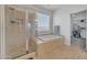 Bright bathroom features glass shower and separate soaking tub at 7129 S Stadium Way, Gilbert, AZ 85298