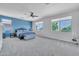 Large main bedroom with blue accent wall, ceiling fan and bright windows at 7129 S Stadium Way, Gilbert, AZ 85298