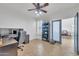Well-lit home office with modern desk, display shelves, and tile flooring at 7129 S Stadium Way, Gilbert, AZ 85298