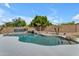 Inviting backyard pool with a rock waterfall feature, mature landscaping, and clear blue water at 7129 S Stadium Way, Gilbert, AZ 85298