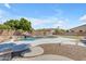 Wide backyard shot featuring in ground pool, lush landscaping, and stone pavers at 7129 S Stadium Way, Gilbert, AZ 85298