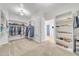 Large walk-in closet with built-in shelving, hanging rods, and an open doorway to the bedroom at 7129 S Stadium Way, Gilbert, AZ 85298