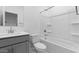 Bathroom featuring gray vanity with a tub and shower with white tile surround at 7434 S 75Th Dr, Laveen, AZ 85339