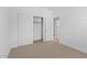 Bedroom with carpet, a closet with sliding doors, and a doorway to another room at 7434 S 75Th Dr, Laveen, AZ 85339