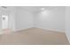 Spacious carpeted bedroom with a doorway to the bathroom and bright, white walls at 7434 S 75Th Dr, Laveen, AZ 85339