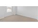 Spacious bedroom with neutral carpet, white walls, and a large window at 7434 S 75Th Dr, Laveen, AZ 85339