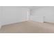 Large, carpeted bonus room with bright, white walls and a doorway at 7434 S 75Th Dr, Laveen, AZ 85339