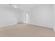 Large bonus room with neutral carpet, bright walls, and a view into the bathroom at 7434 S 75Th Dr, Laveen, AZ 85339