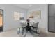 Bright dining area features a modern table, tile floors, and a window at 7434 S 75Th Dr, Laveen, AZ 85339