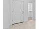 Bright entryway featuring tile floors and a white front door leading to a closet at 7434 S 75Th Dr, Laveen, AZ 85339