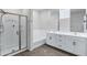 Modern bathroom with a glass-enclosed shower, soaking tub, and dual-sink vanity with sleek fixtures at 751 W Flintlock Way, Chandler, AZ 85286