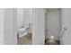Bright half bathroom with sleek wood-look flooring and modern fixtures at 751 W Flintlock Way, Chandler, AZ 85286