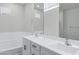 Modern bathroom features a dual sink vanity, soaking tub, and ample space, perfect for relaxation at 751 W Flintlock Way, Chandler, AZ 85286