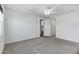Bright bedroom boasts neutral carpet, a ceiling fan, and an ensuite bathroom just behind the door at 751 W Flintlock Way, Chandler, AZ 85286