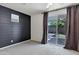Modern bedroom with a shiplap accent wall and sliding glass doors that bring in natural light at 751 W Flintlock Way, Chandler, AZ 85286