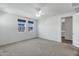 Bright bedroom features neutral carpet, a ceiling fan, and three windows letting in plenty of light at 751 W Flintlock Way, Chandler, AZ 85286