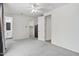 Spacious bedroom with a ceiling fan, carpet flooring, and doors to the bathroom and closet at 751 W Flintlock Way, Chandler, AZ 85286