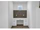 Built-in desk with gray backsplash and drawers for storage, lit by a window at 751 W Flintlock Way, Chandler, AZ 85286