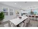 Elegant dining area with large marble table, stylish seating, and bright natural light at 751 W Flintlock Way, Chandler, AZ 85286