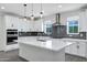Bright kitchen boasts a central island, stainless appliances, and modern cabinetry at 751 W Flintlock Way, Chandler, AZ 85286
