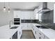 Modern kitchen with stainless steel appliances, white cabinets and a dark backsplash at 751 W Flintlock Way, Chandler, AZ 85286