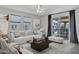 The living room is decorated with a ceiling fan, modern furniture, and a sliding glass door leading to the balcony at 751 W Flintlock Way, Chandler, AZ 85286