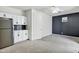 Open living space featuring a kitchenette, built-in cabinets, and a modern accent wall at 751 W Flintlock Way, Chandler, AZ 85286