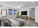 Stylishly furnished primary bedroom features modern decor, a ceiling fan, and plenty of natural light at 751 W Flintlock Way, Chandler, AZ 85286