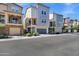 Modern townhomes featuring two-story designs with attached garages and landscaped front yards at 751 W Flintlock Way, Chandler, AZ 85286
