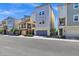 Modern townhomes featuring two-story designs with attached garages and landscaped front yards at 751 W Flintlock Way, Chandler, AZ 85286