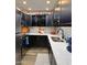 Well-equipped kitchen features dark cabinetry, stainless steel appliances, and quartz countertops at 7625 E Camelback Rd # 310B, Scottsdale, AZ 85251