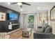 Stylish living room boasts a flat-screen TV, balcony access, and comfortable sofa at 7625 E Camelback Rd # 310B, Scottsdale, AZ 85251