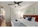 Bright bedroom boasts ceiling fan, wood-look floors and comfortable bed with stylish decor at 7625 E Camelback Rd # A139, Scottsdale, AZ 85251