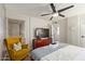 Cozy bedroom featuring stylish ceiling fan, accent chair and dresser with large screen TV at 7625 E Camelback Rd # A139, Scottsdale, AZ 85251