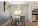 Cozy dining room with modern light fixture and gray and white color palette at 7625 E Camelback Rd # A139, Scottsdale, AZ 85251