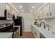 Well-equipped galley kitchen with stainless steel appliances and white shaker cabinets at 7625 E Camelback Rd # A139, Scottsdale, AZ 85251