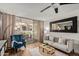 A spacious living room featuring a comfortable seating area, a modern ceiling fan, and a private outdoor patio at 7625 E Camelback Rd # A139, Scottsdale, AZ 85251
