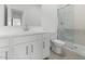Bathroom with white cabinets, shower, toilet, and large mirror at 7638 W Park St, Laveen, AZ 85339