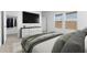 Well-lit bedroom with a large TV, ample closet space, and contemporary furnishings at 7638 W Park St, Laveen, AZ 85339