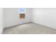 Bedroom with neutral carpet, white walls, and window at 7638 W Park St, Laveen, AZ 85339