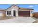 Attractive single-story home displaying a tile roof, stucco facade and a spacious two-car garage at 7638 W Park St, Laveen, AZ 85339