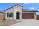 Charming single-story home featuring a tile roof, neutral stucco, and a two-car garage at 7638 W Park St, Laveen, AZ 85339