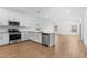 Bright, open kitchen featuring white cabinets, stainless steel appliances, and a large island at 7638 W Park St, Laveen, AZ 85339