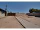 Backyard featuring a wooden gate, dirt and a concrete pathway at 7930 E Broadway Rd, Mesa, AZ 85208