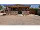 Charming single-story home featuring a stone accent wall and covered front porch at 7930 E Broadway Rd, Mesa, AZ 85208